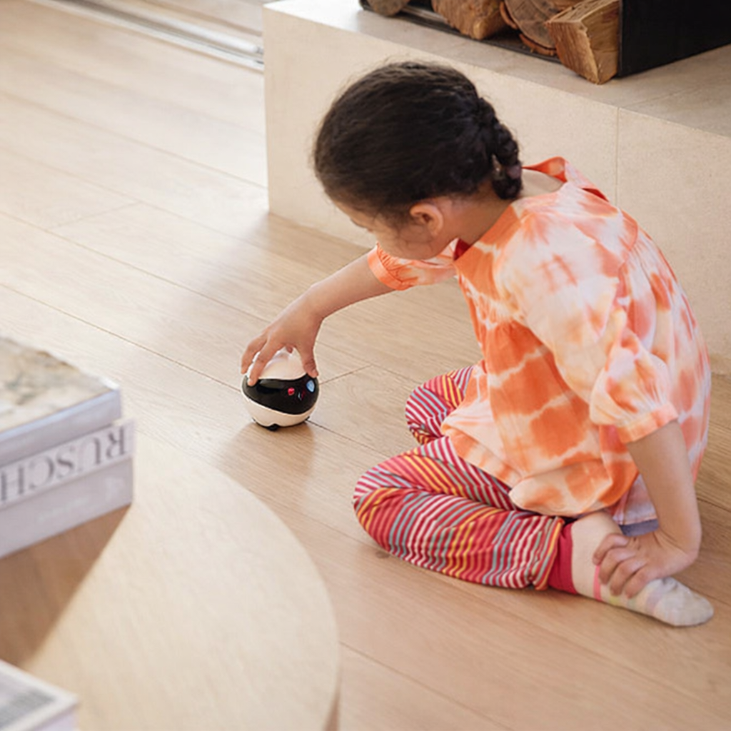 Child playing with RomiPal Expert smart home robot designed for safe family interaction